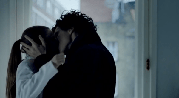 Sherlock and Molly share a passionate kiss after he bursts through the window.